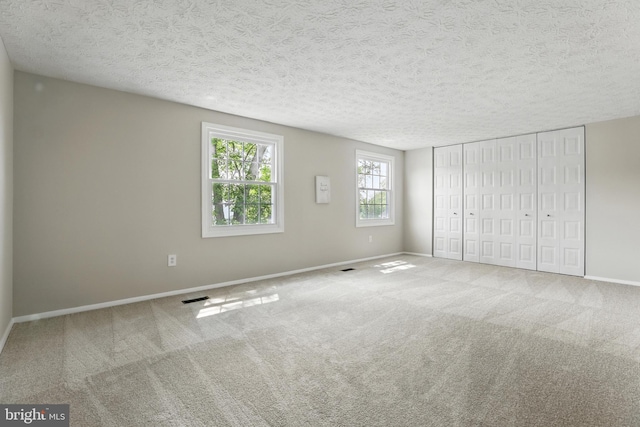 14612 Orangewood St, Silver Spring, MD 20905 - unfurnished bedroom with carpet flooring, baseboards, a textured ceiling, and a closet