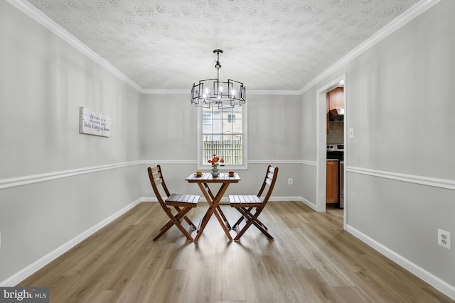 14612 Orangewood St, Silver Spring, MD 20905 - dining space with light wood finished floors, a chandelier, baseboards, ornamental molding, and a textured ceiling