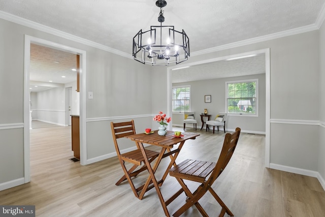 14612 Orangewood St, Silver Spring, MD 20905 - dining room featuring light wood finished floors, a chandelier, baseboards, recessed lighting, and crown molding