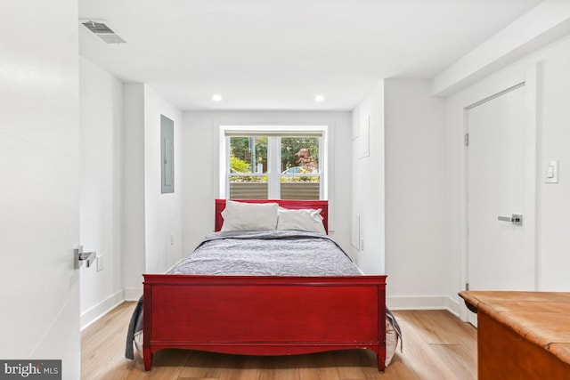 1351 Newton St NW, Washington, DC 20010 - bedroom with light wood-type flooring, electric panel, recessed lighting, and baseboards