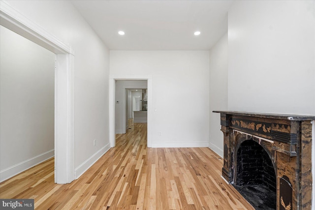 1630 E Biddle St, Baltimore, MD 21213 - unfurnished living room with wood finished floors, a fireplace, baseboards, and recessed lighting