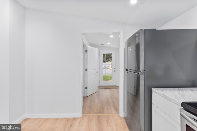 26959 Branchtown Rd, Worton, MD 21678 - kitchen featuring freestanding refrigerator, light wood-style floors, white cabinets, recessed lighting, and baseboards