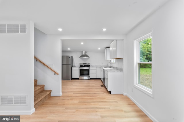 26959 Branchtown Rd, Worton, MD 21678 - kitchen featuring stainless steel appliances, a sink, a heating unit, light wood-style flooring, and white cabinetry