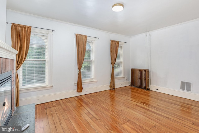 335 W Walnut St, Lancaster, PA 17603 - spare room featuring radiator heating unit, wood-type flooring, baseboards, plenty of natural light, and crown molding
