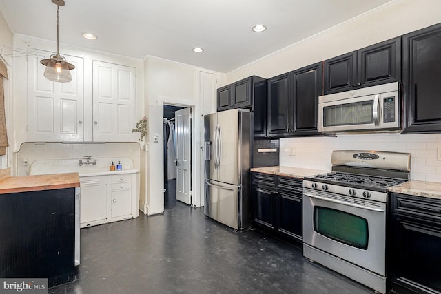 335 W Walnut St, Lancaster, PA 17603 - kitchen featuring appliances with stainless steel finishes, dark cabinets, decorative backsplash, recessed lighting, and wooden counters
