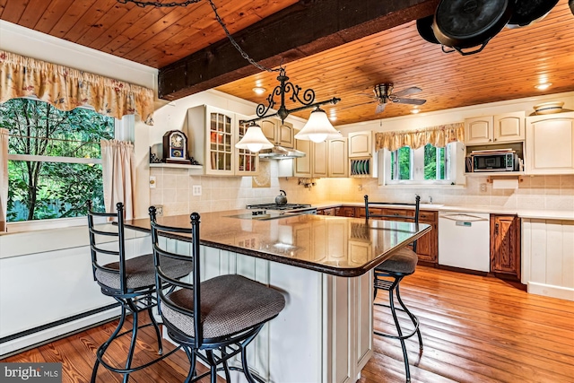 4441 Solomons Island Rd, Harwood, MD 20776 - kitchen with white dishwasher, wooden ceiling, a breakfast bar, stainless steel microwave, and light wood-style floors