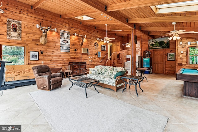 4441 Solomons Island Rd, Harwood, MD 20776 - living room with wood walls, a wood ceiling with exposed beams, ceiling fan, light tile patterned floors, and a skylight