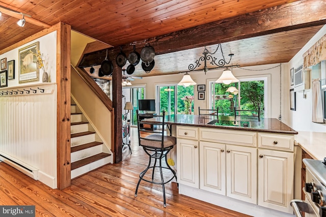 4441 Solomons Island Rd, Harwood, MD 20776 - kitchen with baseboard heating, a wooden ceiling with exposed beams, wood finished floors, hanging light fixtures, and a ceiling fan