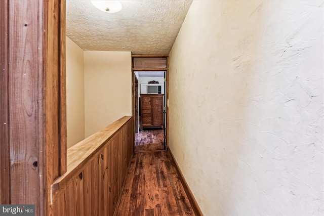 4441 Solomons Island Rd, Harwood, MD 20776 - hallway featuring a textured ceiling and dark wood finished floors