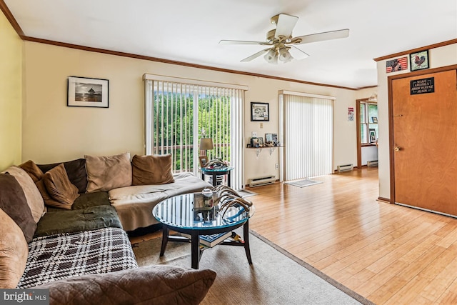 4441 Solomons Island Rd, Harwood, MD 20776 - living area featuring a baseboard heating unit, wood finished floors, crown molding, and a ceiling fan