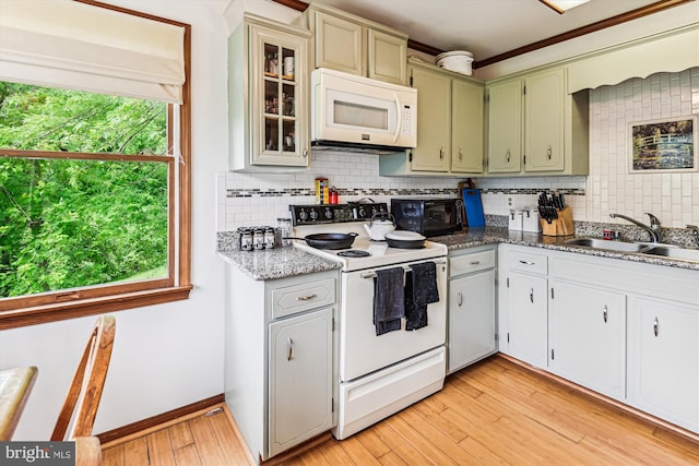4441 Solomons Island Rd, Harwood, MD 20776 - kitchen featuring white appliances, light wood-style flooring, backsplash, glass insert cabinets, and crown molding