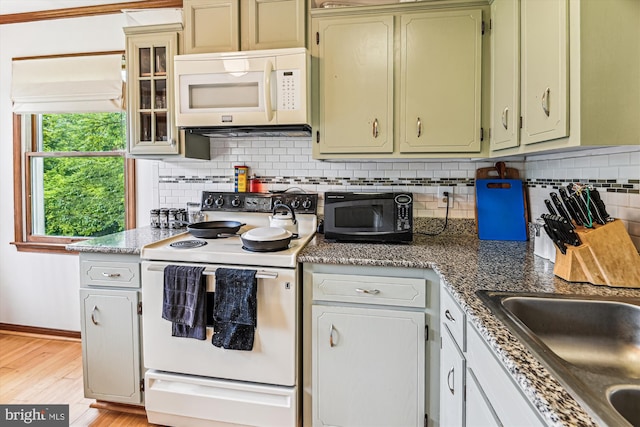 4441 Solomons Island Rd, Harwood, MD 20776 - kitchen featuring white appliances, light wood-style floors, decorative backsplash, and glass insert cabinets