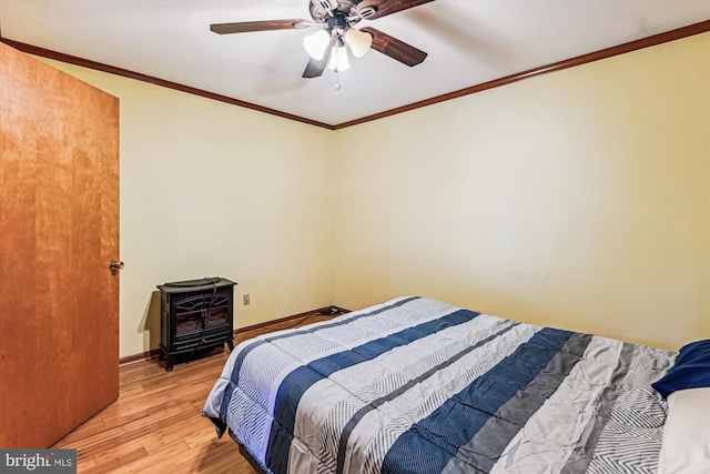 4441 Solomons Island Rd, Harwood, MD 20776 - bedroom featuring light wood-style floors, a wood stove, crown molding, and a ceiling fan