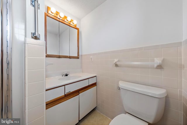 18 Old Whaling Ln, Long Beach Township, NJ 08008 - bathroom featuring vanity, tile walls, and wainscoting