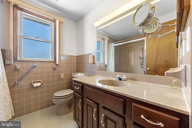 18 Old Whaling Ln, Long Beach Township, NJ 08008 - bathroom featuring vanity, tile walls, curtained shower, and wainscoting