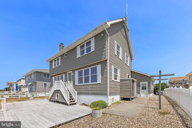 18 Old Whaling Ln, Long Beach Township, NJ 08008 - back of property with a chimney and a wooden deck