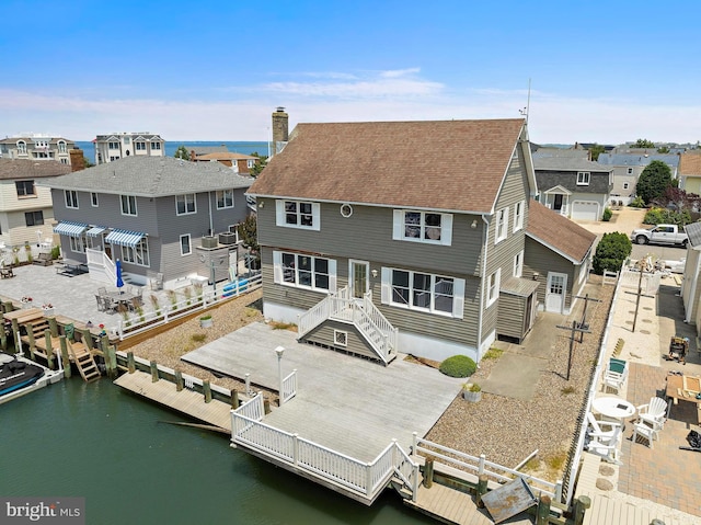 18 Old Whaling Ln, Long Beach Township, NJ 08008 - back of house with a chimney, roof with shingles, a water view, and a residential view