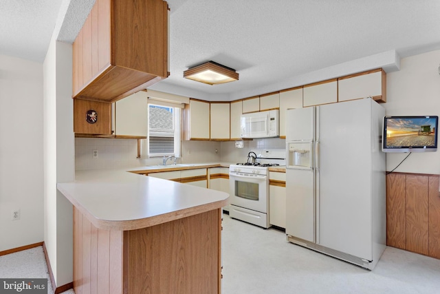 18 Old Whaling Ln, Long Beach Township, NJ 08008 - kitchen featuring white appliances, a peninsula, light countertops, tasteful backsplash, and a textured ceiling