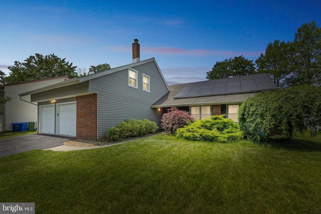 17 Concord Rd, Marlton, NJ 08053 - property exterior at dusk featuring brick siding, solar panels, driveway, an attached garage, and a yard