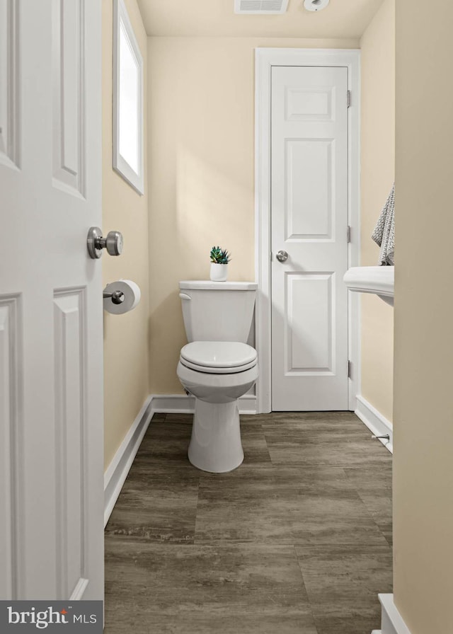 303 Conway Ave, Narberth, PA 19072 - bathroom with baseboards, toilet, and wood finished floors