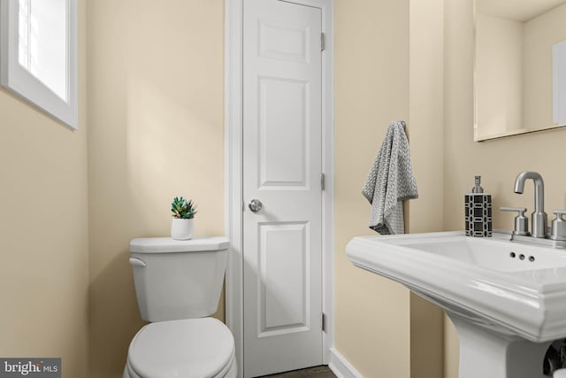 303 Conway Ave, Narberth, PA 19072 - half bathroom with toilet, a sink, and baseboards