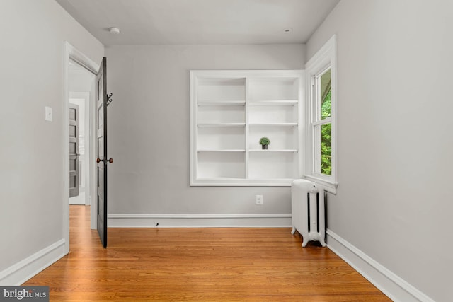 303 Conway Ave, Narberth, PA 19072 - unfurnished room with radiator, baseboards, wood finished floors, and a smoke detector