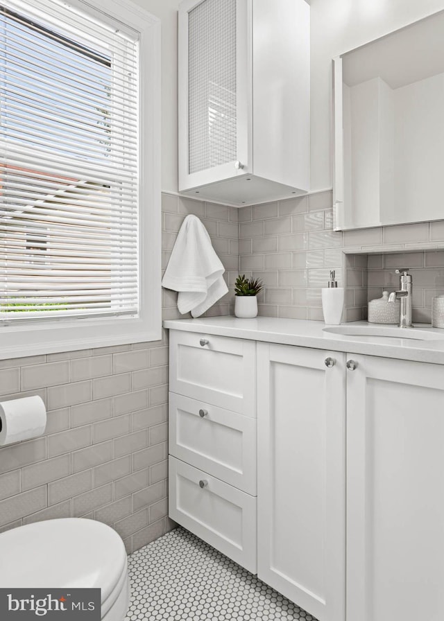 303 Conway Ave, Narberth, PA 19072 - kitchen featuring a sink, light countertops, white cabinets, tile walls, and light tile patterned floors