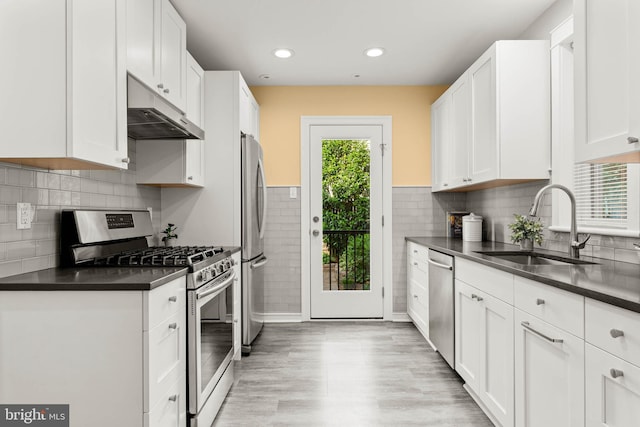 303 Conway Ave, Narberth, PA 19072 - kitchen with appliances with stainless steel finishes, under cabinet range hood, dark countertops, a sink, and recessed lighting