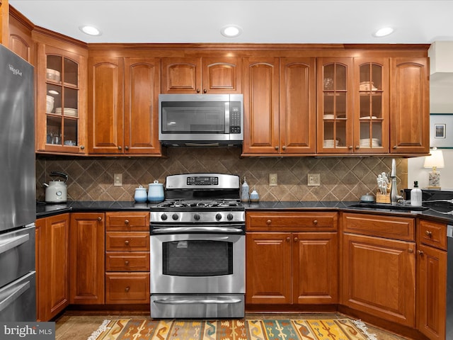 2772 Gingerview Ln, Annapolis, MD 21401 - kitchen featuring stainless steel appliances, dark countertops, brown cabinets, and recessed lighting