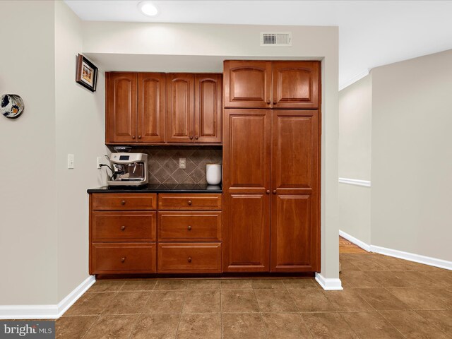 2772 Gingerview Ln, Annapolis, MD 21401 - kitchen featuring tasteful backsplash, baseboards, brown cabinetry, dark countertops, and recessed lighting