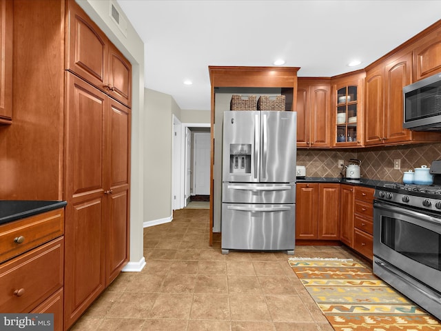 2772 Gingerview Ln, Annapolis, MD 21401 - kitchen with stainless steel appliances, baseboards, backsplash, dark countertops, and glass insert cabinets