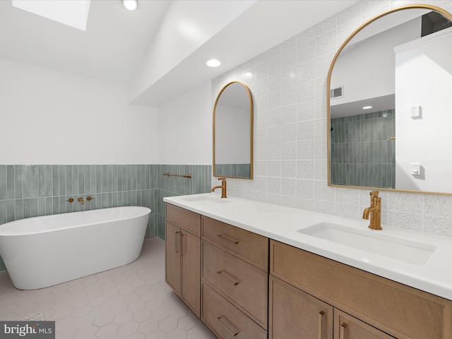2772 Gingerview Ln, Annapolis, MD 21401 - bathroom with tile walls, double vanity, a soaking tub, recessed lighting, and tile patterned flooring