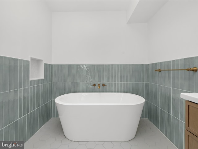 2772 Gingerview Ln, Annapolis, MD 21401 - full bath featuring tile walls, a freestanding bath, vanity, wainscoting, and tile patterned floors
