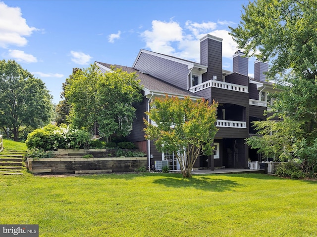 2772 Gingerview Ln, Annapolis, MD 21401 - back of house with a lawn, a balcony, cooling unit, and a chimney