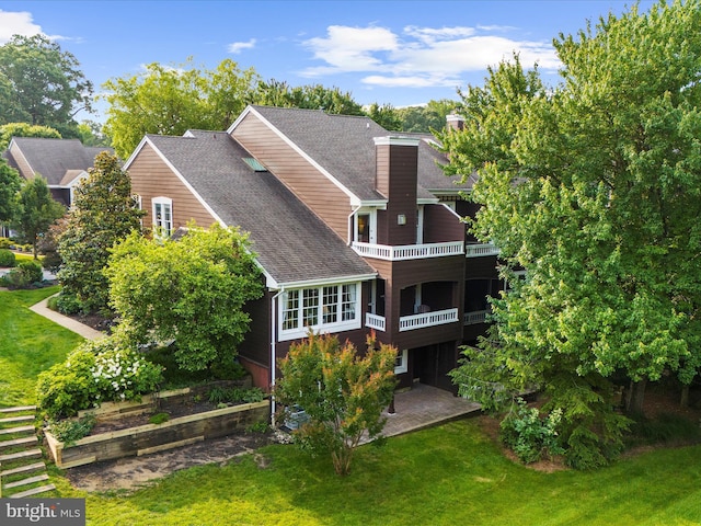 2772 Gingerview Ln, Annapolis, MD 21401 - back of property with a balcony, a yard, a chimney, a shingled roof, and a patio