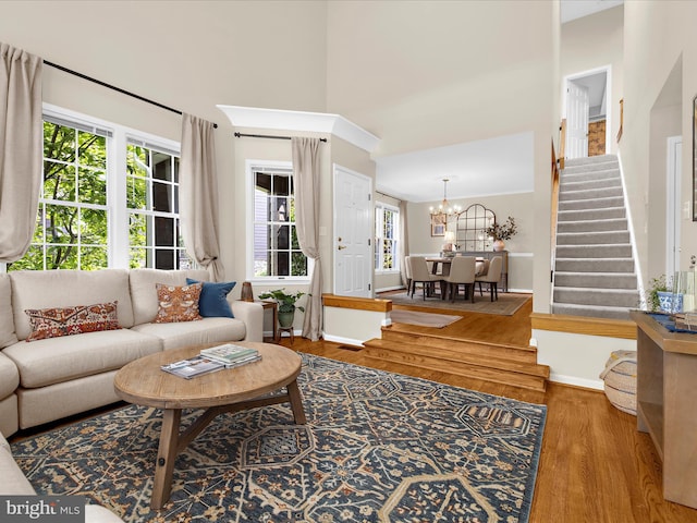 2772 Gingerview Ln, Annapolis, MD 21401 - living room with stairs, wood finished floors, a chandelier, baseboards, and a towering ceiling