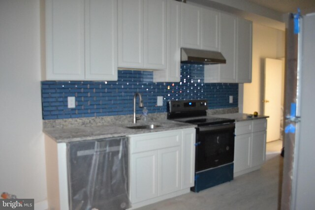 3111 E Baltimore St, Baltimore, MD 21224 - kitchen with black range with electric cooktop, under cabinet range hood, a sink, and tasteful backsplash