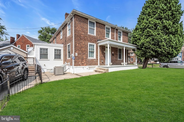 2923 Wasp Rd, Camden, NJ 08104 - view of front of house featuring brick siding, a chimney, central AC, and covered porch