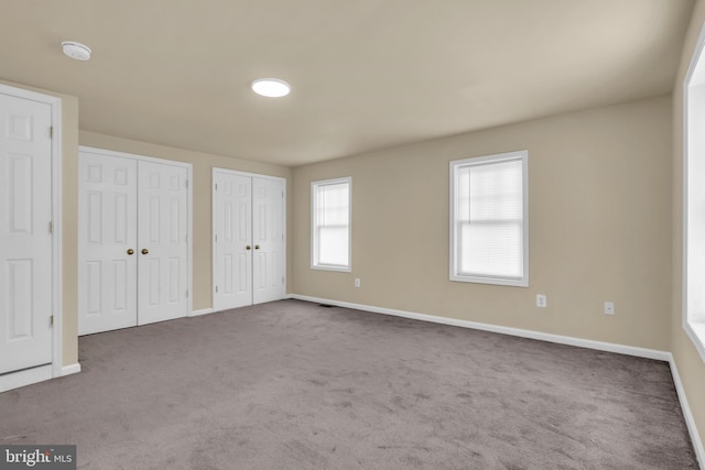2923 Wasp Rd, Camden, NJ 08104 - unfurnished bedroom featuring baseboards, two closets, and carpet floors