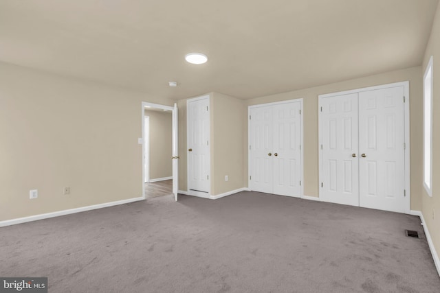 2923 Wasp Rd, Camden, NJ 08104 - unfurnished bedroom with two closets, baseboards, and dark carpet