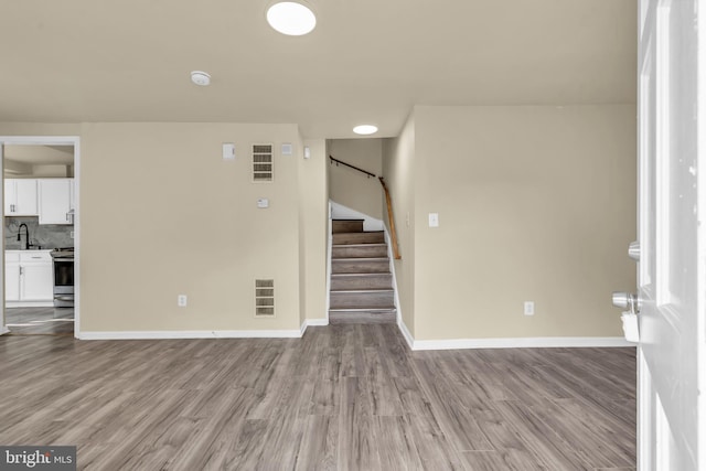 2923 Wasp Rd, Camden, NJ 08104 - empty room with stairway, wood finished floors, baseboards, and a smoke detector