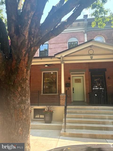 4938 Walton Ave, Philadelphia, PA 19143 - view of front of property featuring a porch and brick siding