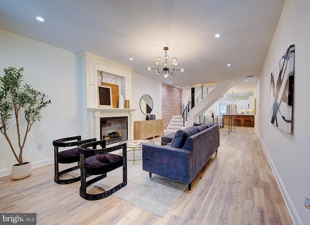4938 Walton Ave, Philadelphia, PA 19143 - living room with a chandelier, stairway, a fireplace, light wood finished floors, and recessed lighting