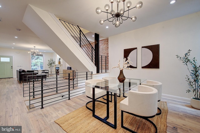4938 Walton Ave, Philadelphia, PA 19143 - dining area with a chandelier, wood finished floors, recessed lighting, and stairs