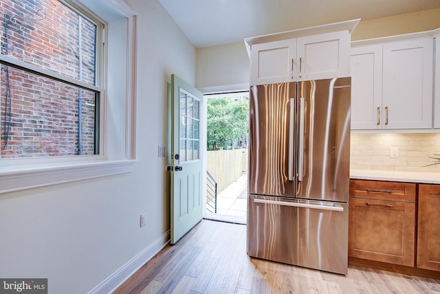 4938 Walton Ave, Philadelphia, PA 19143 - kitchen with freestanding refrigerator, white cabinetry, light wood finished floors, and light countertops