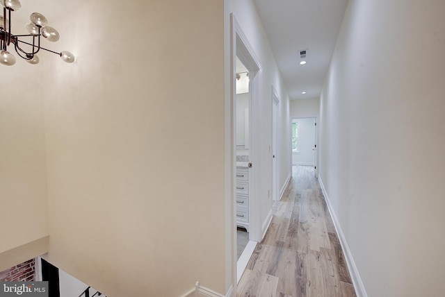 4938 Walton Ave, Philadelphia, PA 19143 - hallway featuring light wood-type flooring, a chandelier, and recessed lighting
