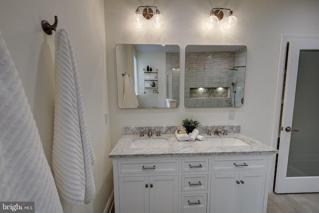 4938 Walton Ave, Philadelphia, PA 19143 - full bath featuring double vanity, tiled shower, and wood finished floors