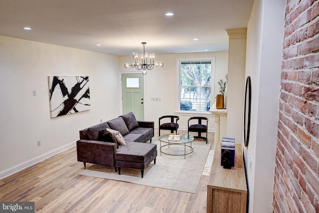 4938 Walton Ave, Philadelphia, PA 19143 - living room featuring light wood-type flooring, brick wall, a chandelier, and recessed lighting
