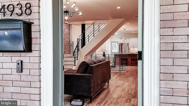 4938 Walton Ave, Philadelphia, PA 19143 - living room with light wood-type flooring, stairway, a chandelier, and recessed lighting