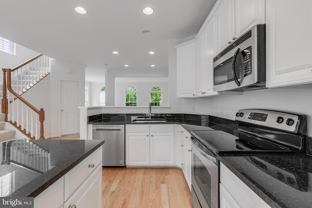 5454 Patuxent Knoll Pl, Alexandria, VA 22312 - kitchen with appliances with stainless steel finishes, a sink, light wood-style floors, white cabinets, and recessed lighting